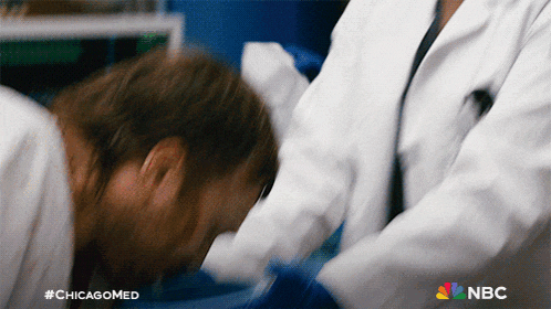 a close up of a person being examined by a doctor with nbc written on the bottom right