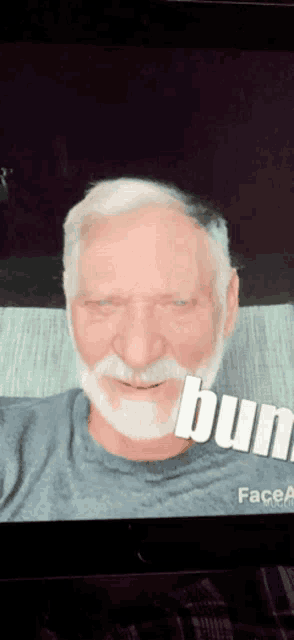 a man with a beard and mustache is smiling with the word bun below him