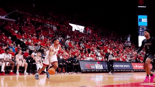 a basketball game is being played in front of a large crowd and the scoreboard says big