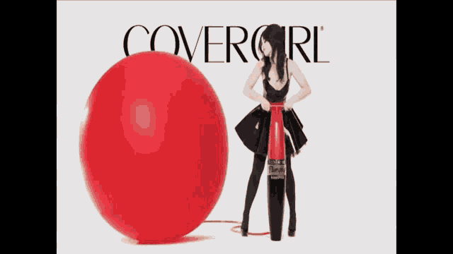 a woman is pumping a red balloon in front of a covergirl ad .