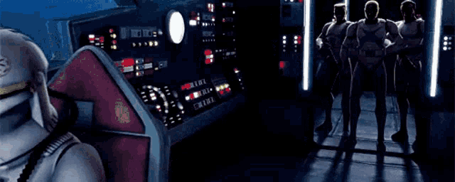 a group of stormtroopers are standing in front of a control panel in a dark room .