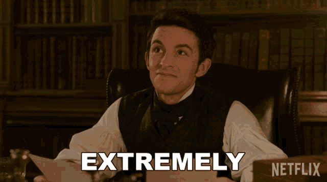 a man sitting at a desk with a piece of paper that says extremely netflix on the bottom