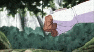 a person is holding a knife in their fist in front of trees .