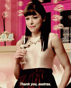 a woman is holding a glass of wine and saying thank you sestras