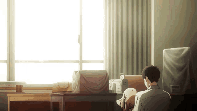 a man sits at a desk with a woman laying on his lap in front of a window ..
