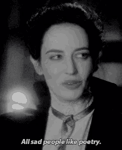 a black and white photo of a woman saying `` all sad people like poetry ''