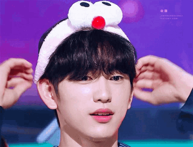 a close up of a person 's face with a headband on