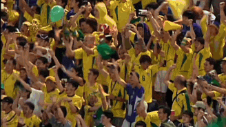 a crowd of people in yellow shirts with the number 8 on their shirt