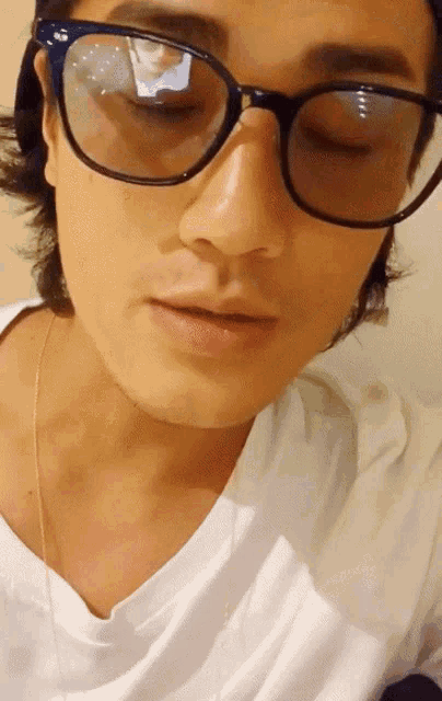 a close up of a person wearing glasses and a hat