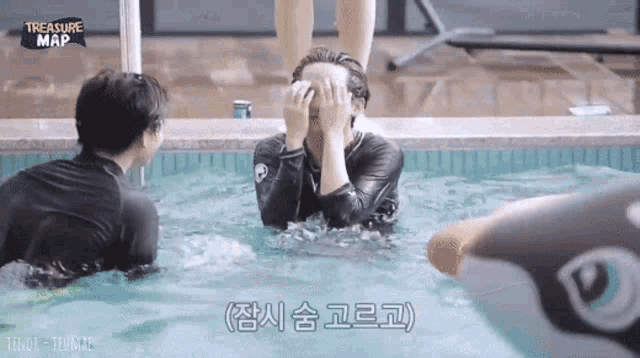 a group of people are playing in a swimming pool with a sign that says treasure map
