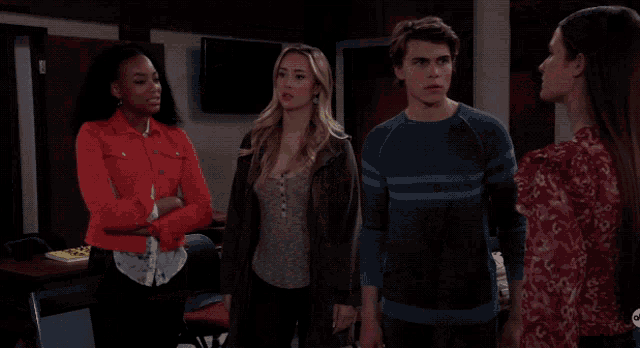 a woman with a surprised look on her face stands between two other women