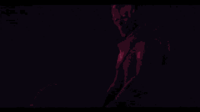a person is holding a red lightsaber in their hand