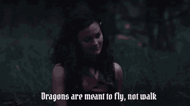 a woman says dragons are meant to fly not walk in front of a fire