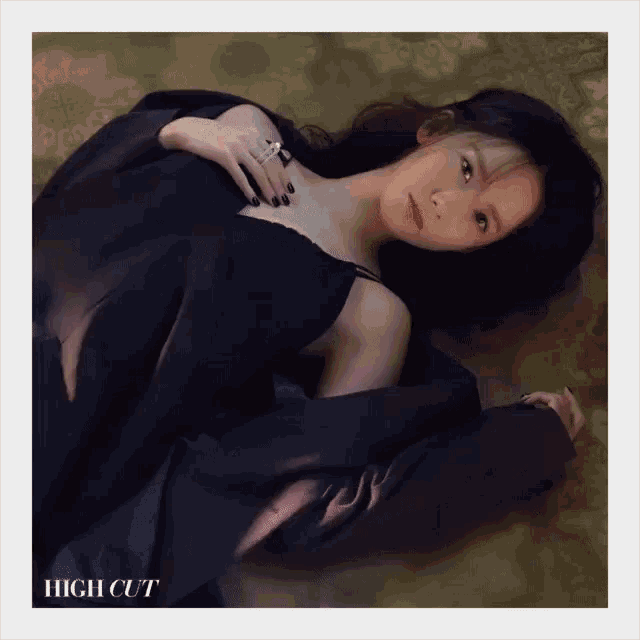 a woman in a black dress is laying on the floor with the words high cut behind her