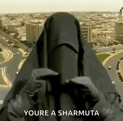 a woman wearing a niqab is holding a cell phone and says you 're a sharmuta