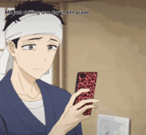 a man with a bandana on his head is holding a cell phone