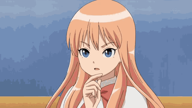 a girl with long blonde hair and blue eyes is sitting in front of a tv screen that says tokyo