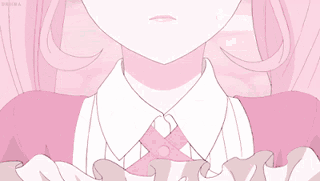 a close up of a girl 's neck with a pink ribbon around it