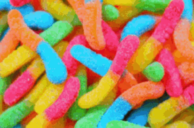 a pile of red and white candy that looks like fake teeth