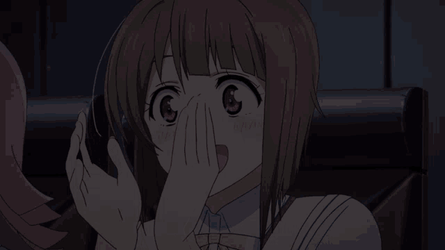 a girl with a surprised look on her face covering her mouth with her hands