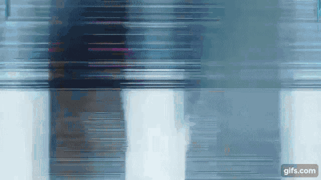 a blurry picture of a building with a gifs.com icon in the bottom right corner