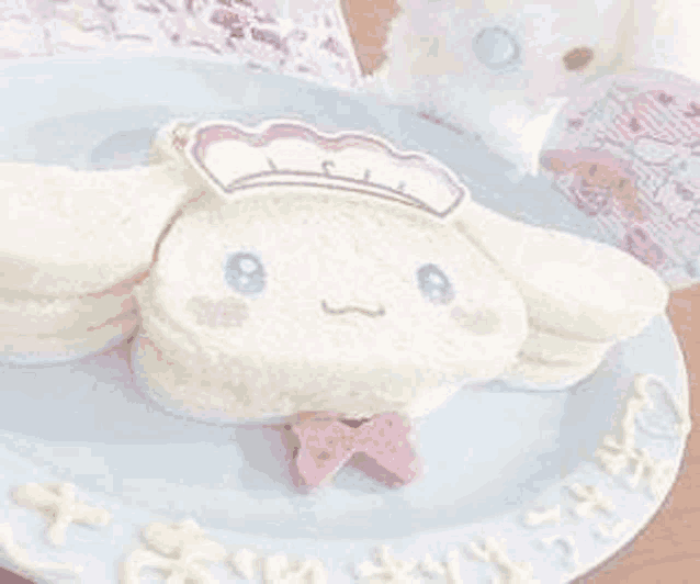 a white plate topped with a sandwich in the shape of a cinnamoroll .