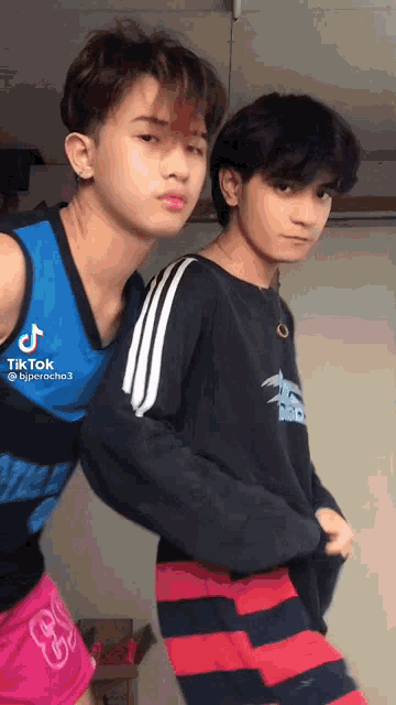two young men are standing next to each other and one of them has a tik tok account