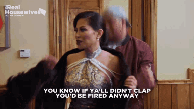 a woman in a dress is being held by a man in a real housewives advertisement