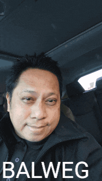 a man in a car with balweg written on the bottom right