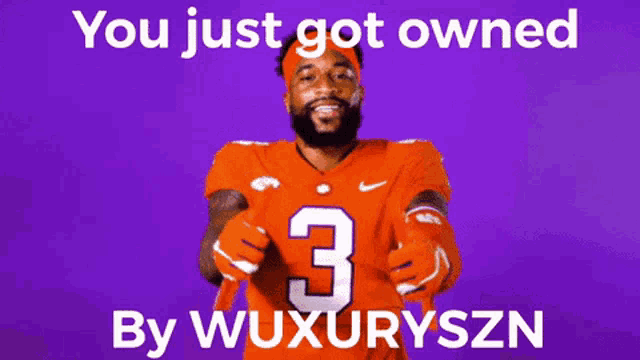 a football player wearing an orange jersey with the number 3 on it