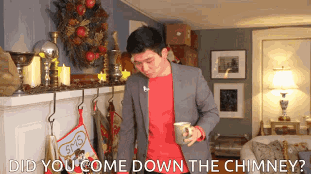 a man in a suit holds a mug in front of a fireplace with the words " did you come down the chimney " above him