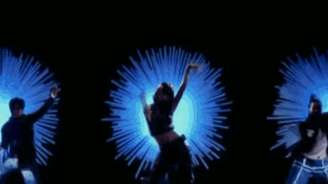 a woman is dancing in front of a blue light burst .