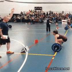 a woman lifting a barbell in a gym with a sign that says 138