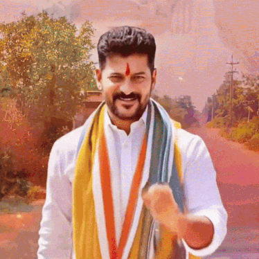 a man with a red star on his forehead is wearing a white shirt and a scarf around his neck