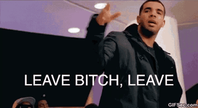 a man in a black jacket is standing in front of a crowd and says leave bitch leave