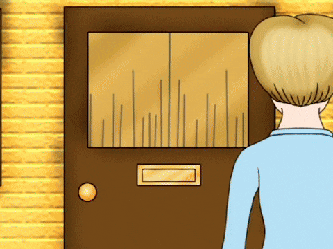 a man in a blue shirt is standing in front of a door