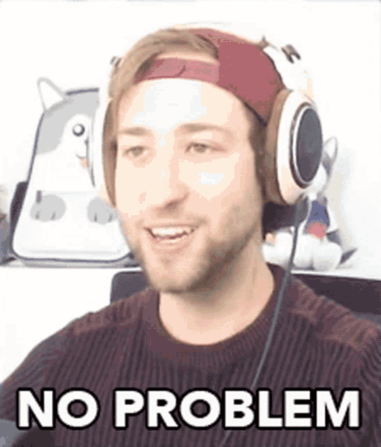 a man wearing headphones and a headband is making a funny face and saying `` no problem '' .