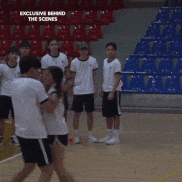 a group of people standing on a basketball court with the words exclusive behind the scenes