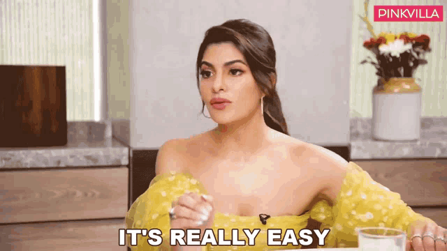 a woman in a yellow dress says it 's really easy in front of a pinkvilla logo