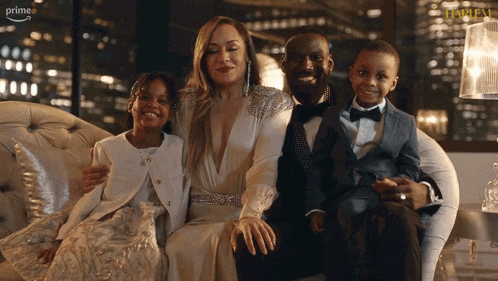 a family sitting on a couch with the word prime on the bottom left