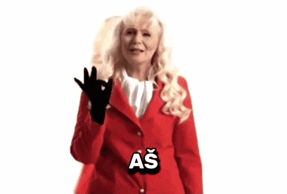 a woman in a red jacket and black gloves is giving an ok sign
