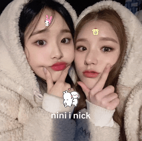 two girls are posing for a picture and the words nini i nick are on the bottom right