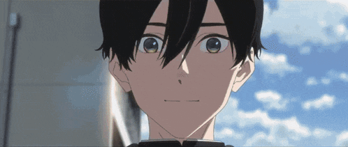 a close up of a boy 's face with a blue sky behind him