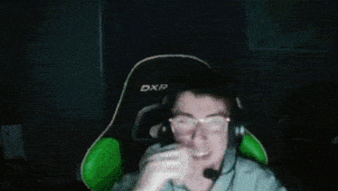 a man wearing headphones and a black shirt with the word dx on it