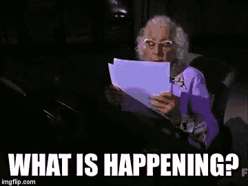 an elderly woman is reading a piece of paper with the words `` what is happening ? '' below her .