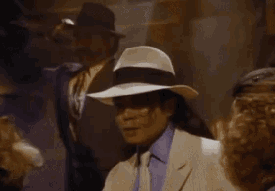 a man in a white hat is standing in front of a purple light