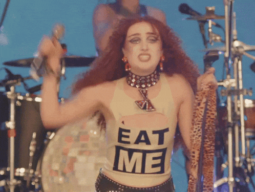 a woman with red hair wears a shirt that says eat me