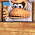 a pixel art of a monkey with a hamburger in his mouth .