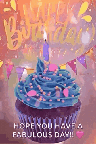 a birthday cupcake with blue frosting and sprinkles and a candle .