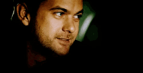 a close up of a man 's face with his eyes closed and a smile on his face .
